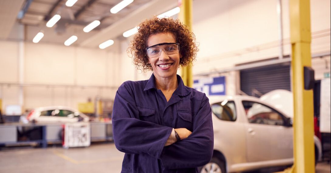 The importance of promoting eye safety in the workplace - Woman at auto shop with prescription safety glasses